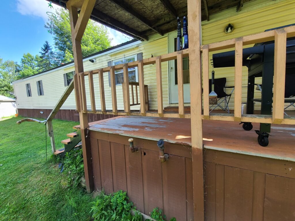 Porch deck before: old railings and stairs that were unsafe and not up to code